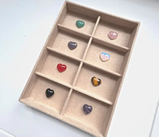 Artistic display of crystals including citrine, green aventurine, and tiger’s eye, arranged to symbolize abundance and wealth.