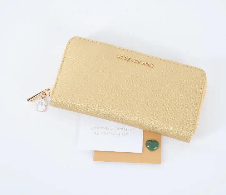 A stylish, well-organized wallet with gold coins and lucky charms, symbolizing financial abundance and prosperity through Feng Shui principles.