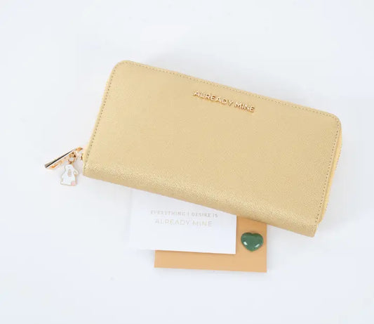 A stylish, well-organized wallet with gold coins and lucky charms, symbolizing financial abundance and prosperity through Feng Shui principles.