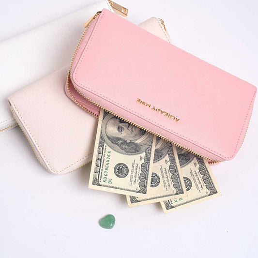 Three Feng Shui wallets in calming colors—ecru, pink, and white—arranged neatly to reflect balance and intentional energy, aligning with the theme 'Wear What Aligns With Your Energy'.