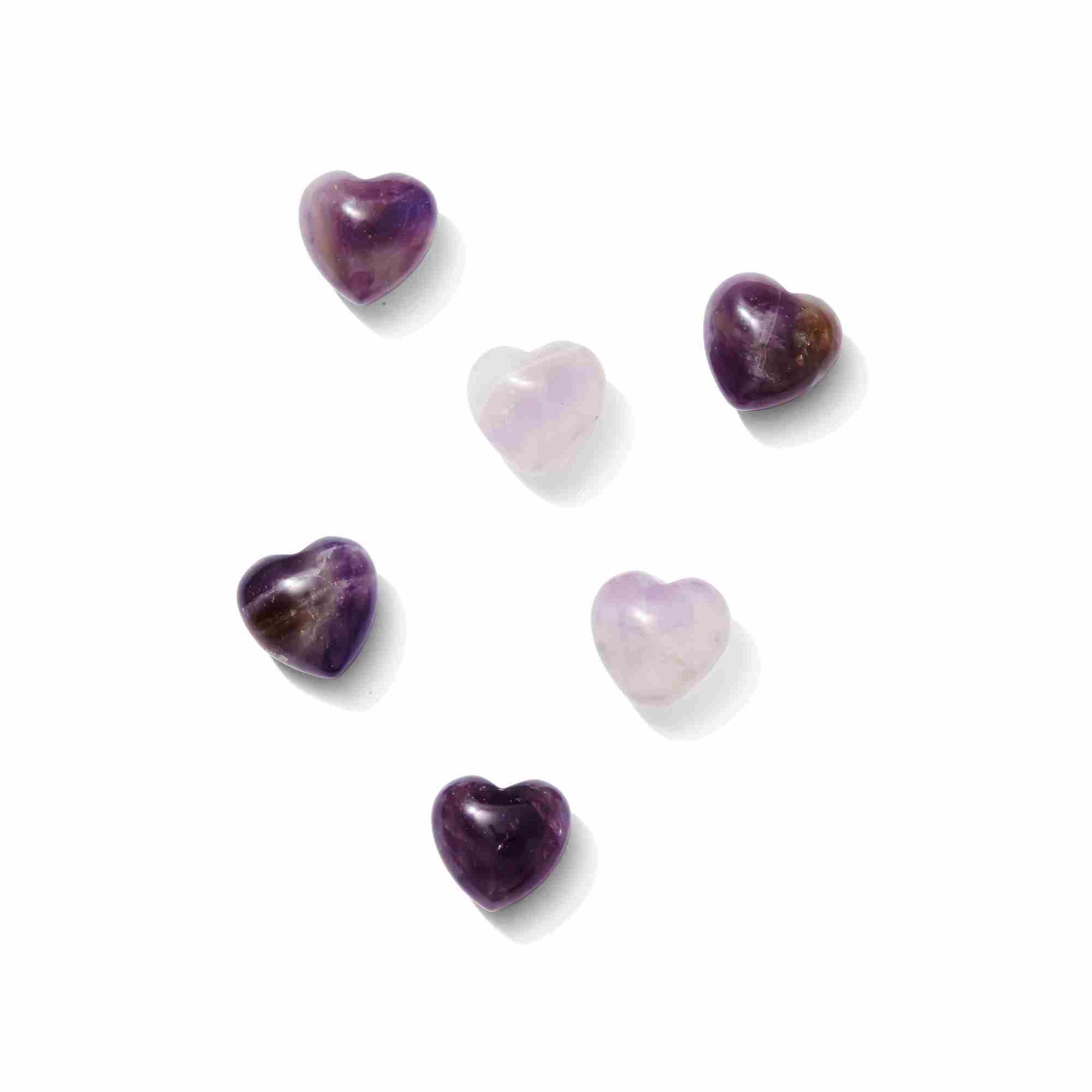 A polished deep purple Amethyst heart-shaped crystal showing natural internal fractures and light-catching facets.
