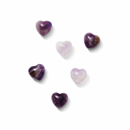 A polished deep purple Amethyst heart-shaped crystal showing natural internal fractures and light-catching facets.