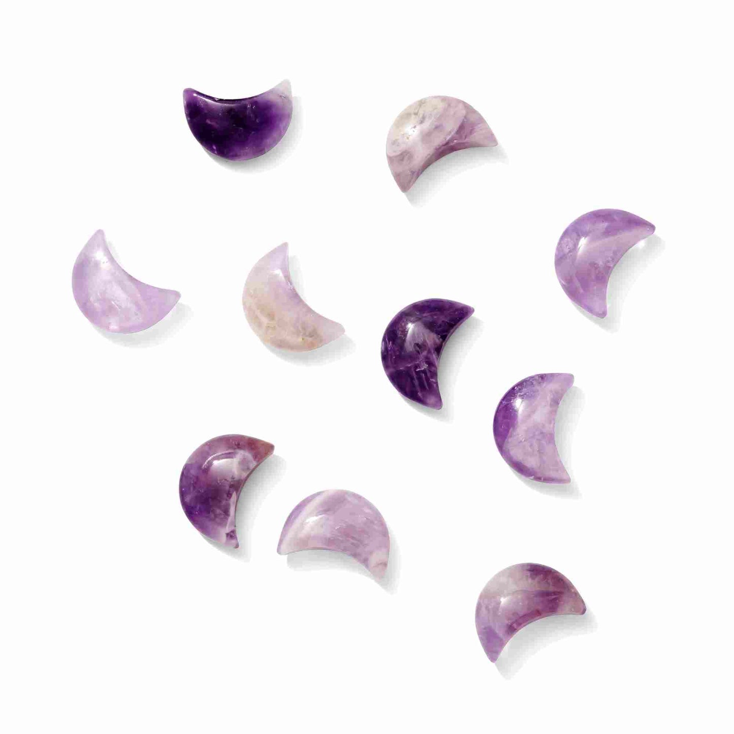 A polished Amethyst crystal carved into a crescent moon shape, displaying deep purple hues and natural crystalline inclusions.