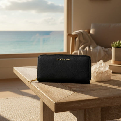 Black Feng Shui manifestation wallet styled with candle and crystals for protection and energetic boundaries
